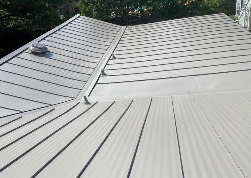 Solar attic fan installed on a metal roof for Roof Ventilation in Alpharetta
