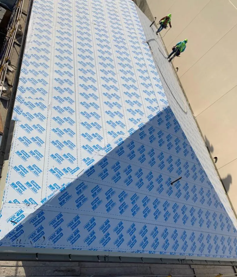 Professional roofers installing underlayment on a metal roof in Alpharetta